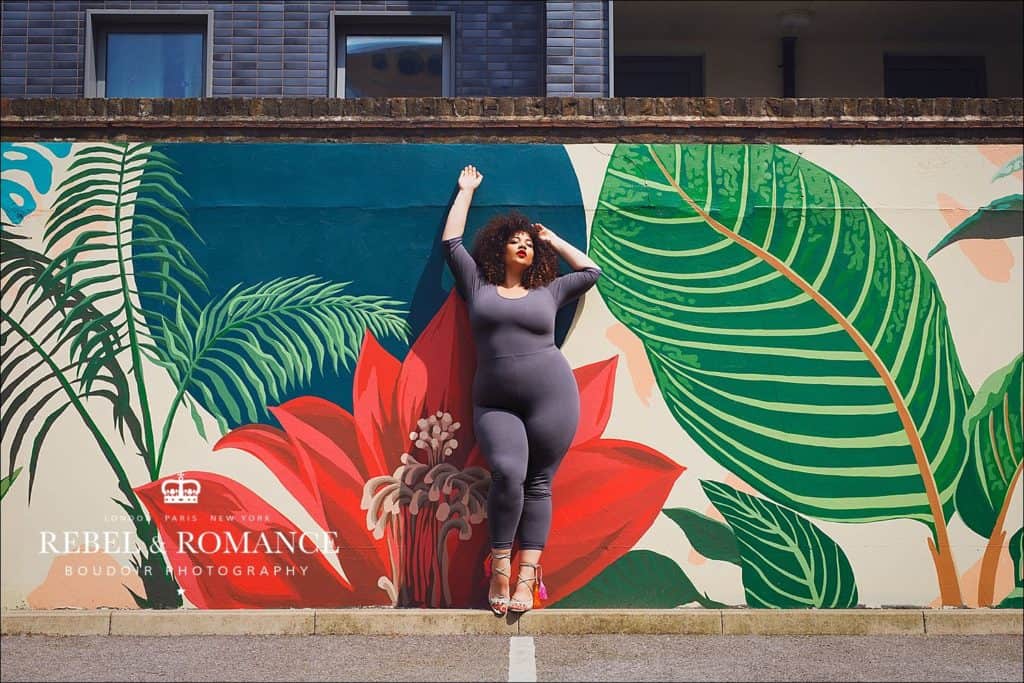 plus size model in front of tropical wall mural by Hicks & Hicks