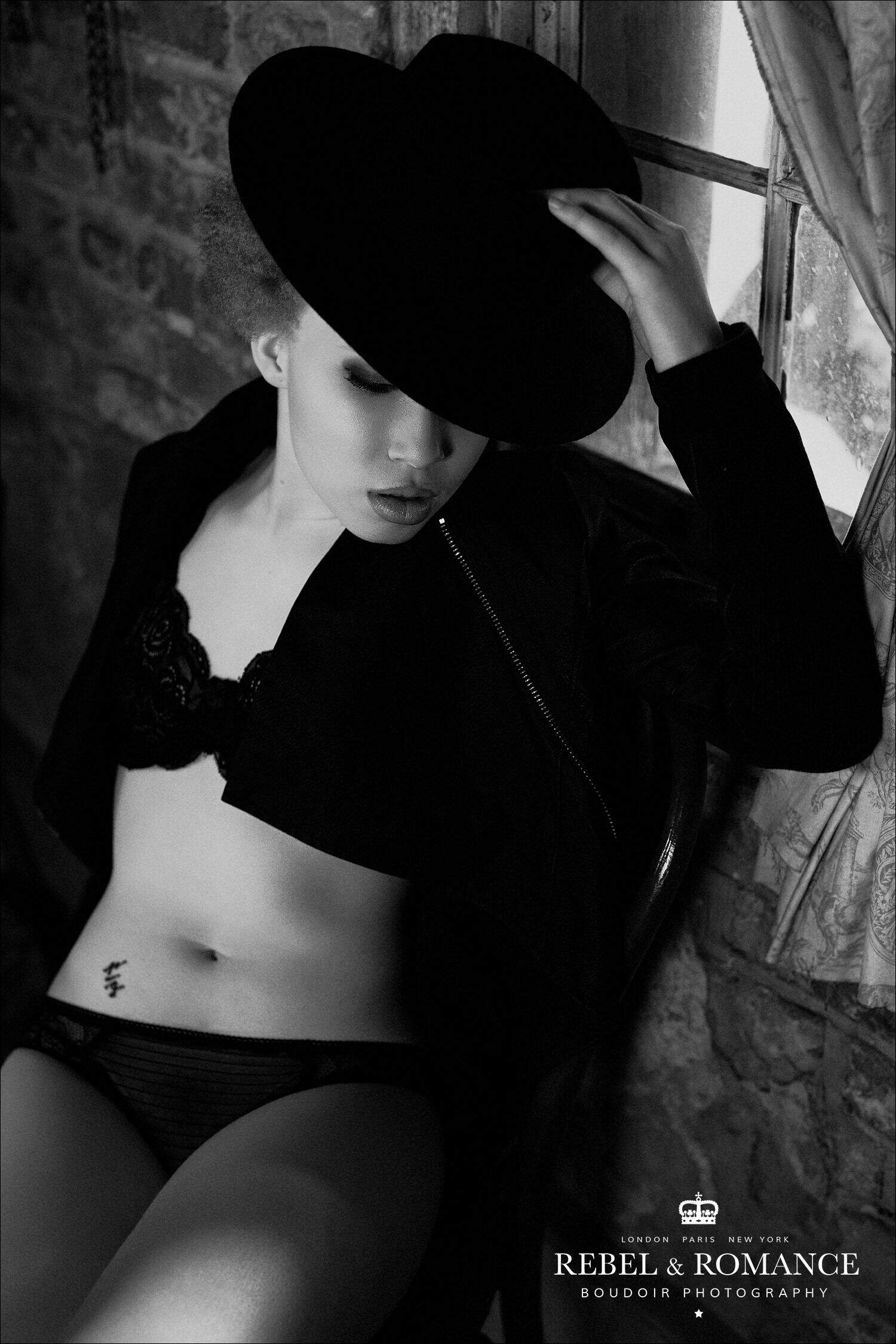 black and white photo of black woman wearing lingerie and a hat in nola