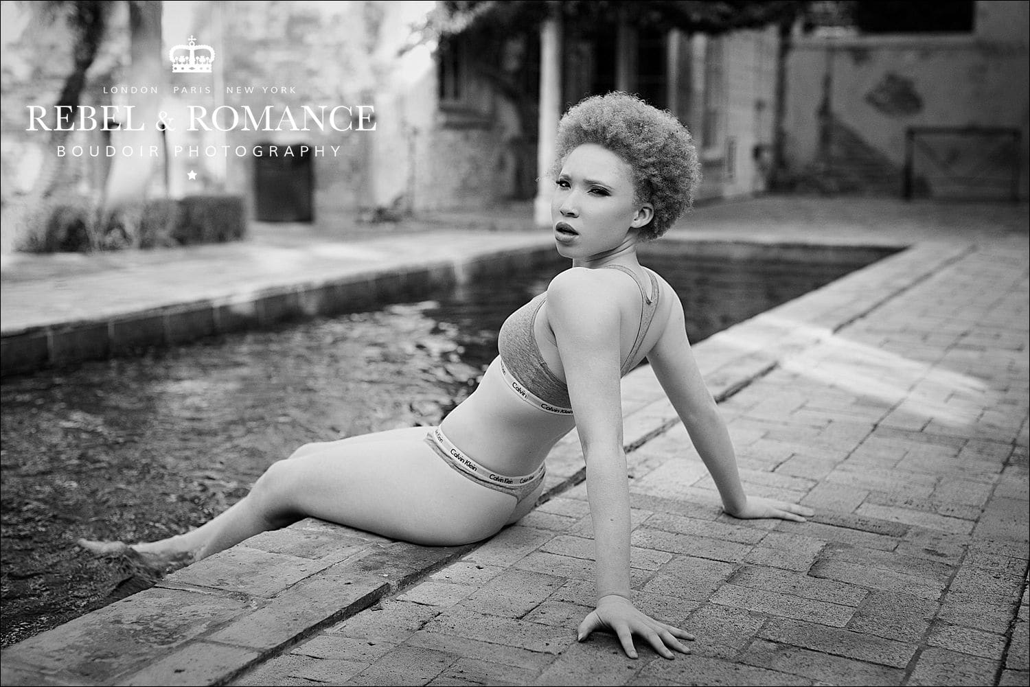 lingeire photoshoot of black girl with ginger afro by the pool in new orleans