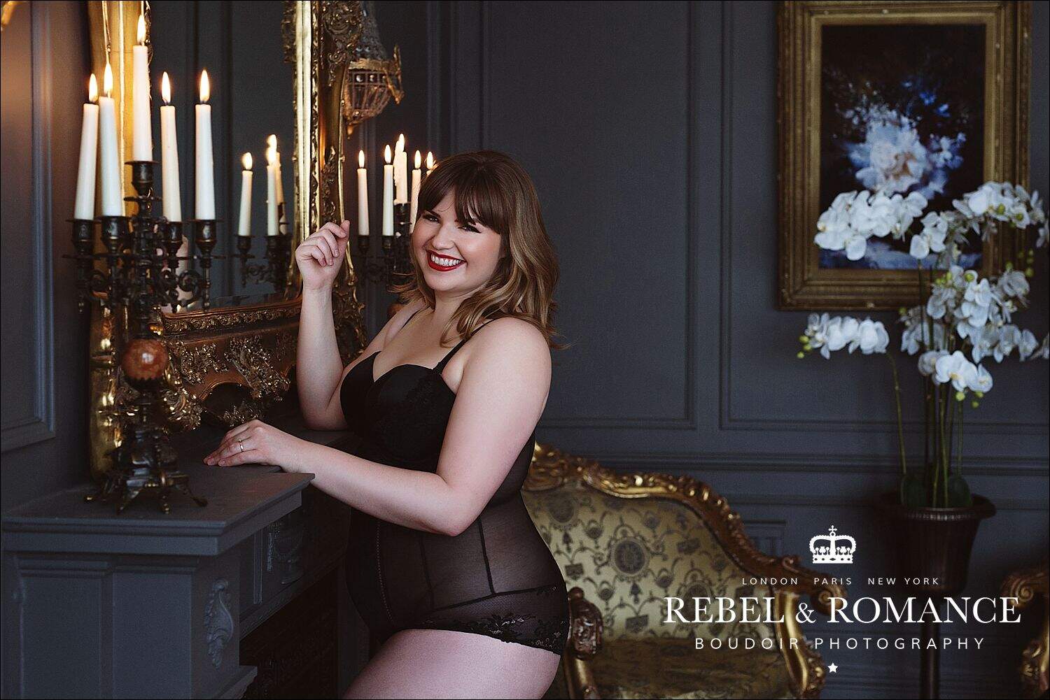 curvy woman in london black lingerie front of mirror and candles