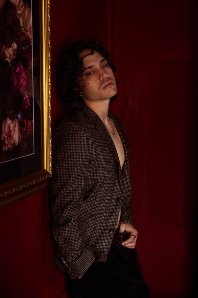 Man in brown patterned suit jacket, editorial portrait during London couples photoshoot