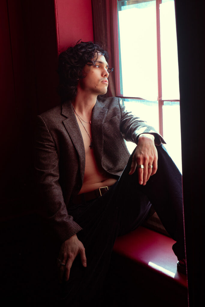 Andrew in hotel room with window light, editorial portrait London