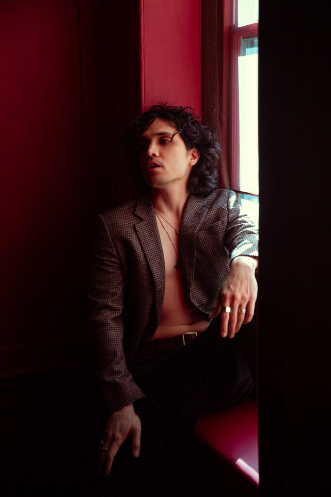 Men's boudoir photography in hotel room with window light, editorial portrait London