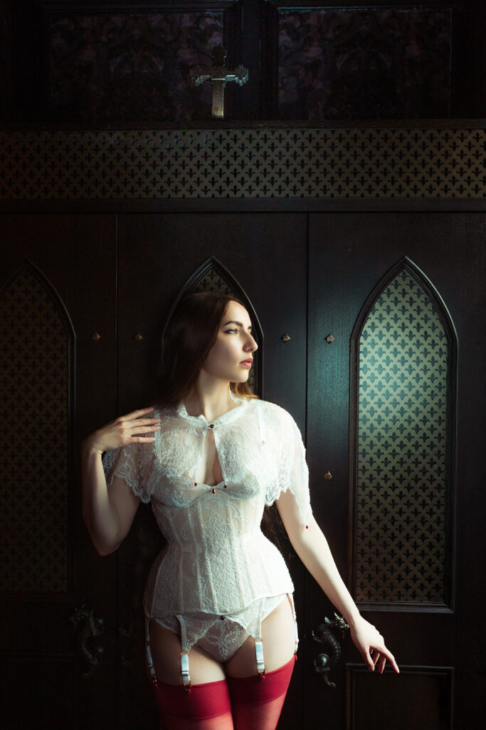 Karolina in custom cream corset against a confessional, editorial London photoshoot