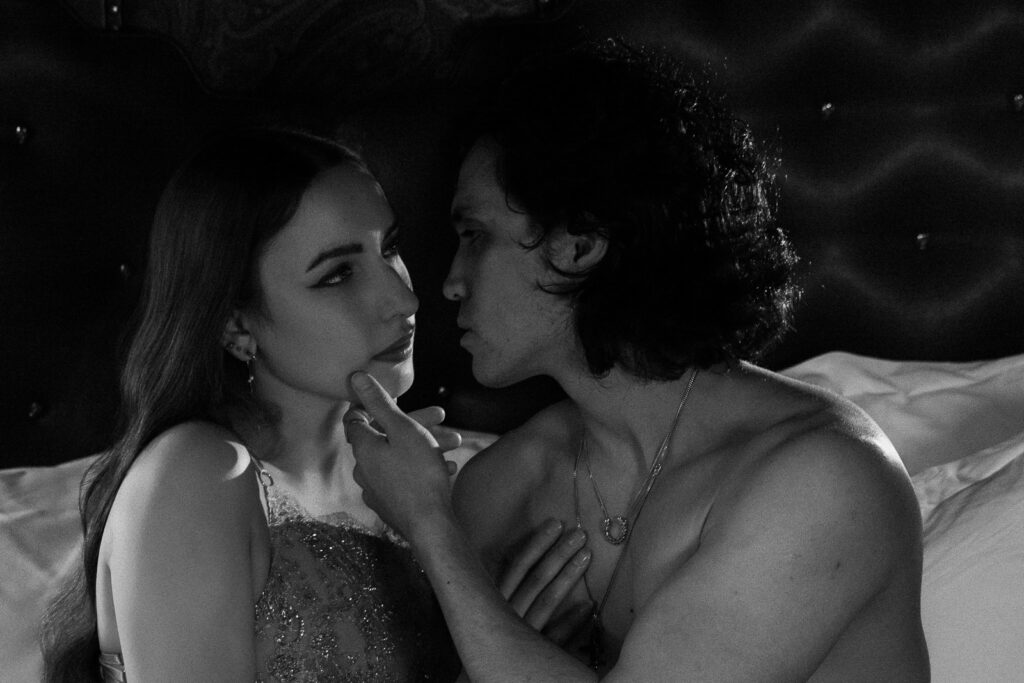 Black and white intimate couples portrait in moody hotel setting, London