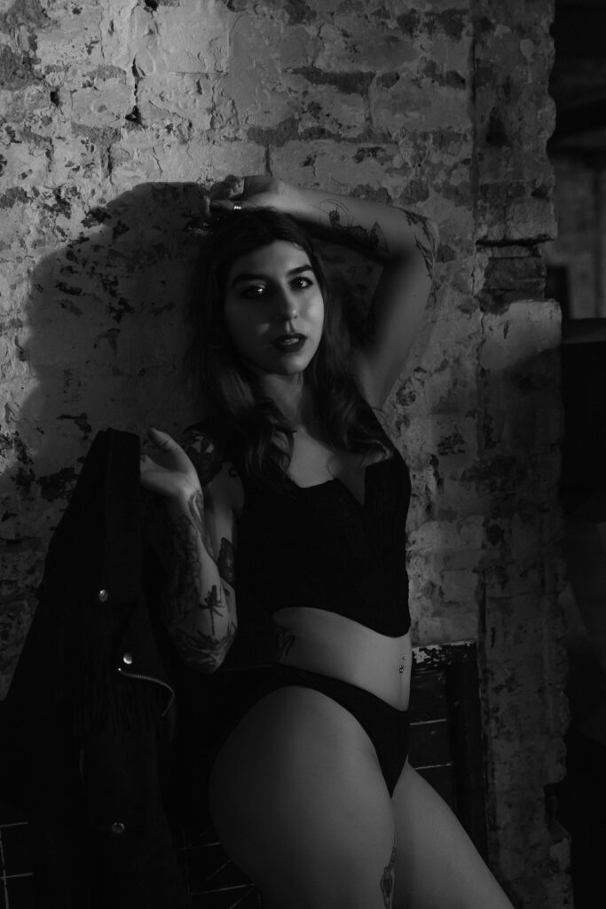 Black and white boudoir photography London warehouse, brick wall