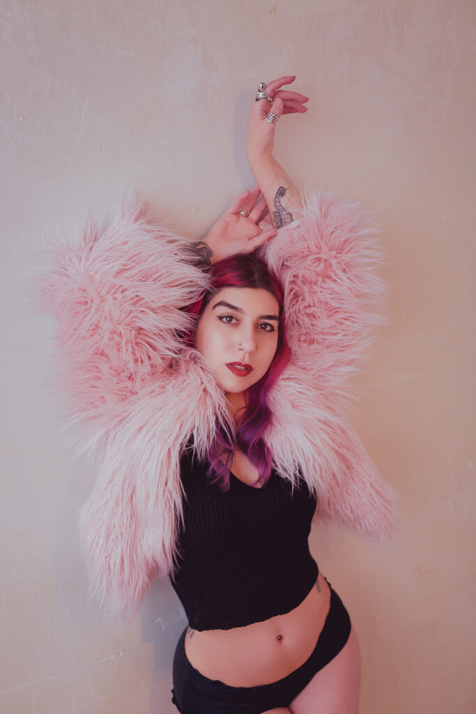 London warehouse boudoir shoot, woman with alternative hair and a pink faux fur coat