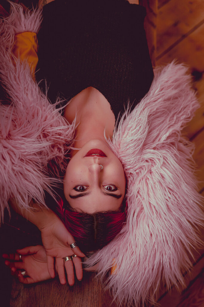 Dramatic photography portrait, pink fur and facial piercing