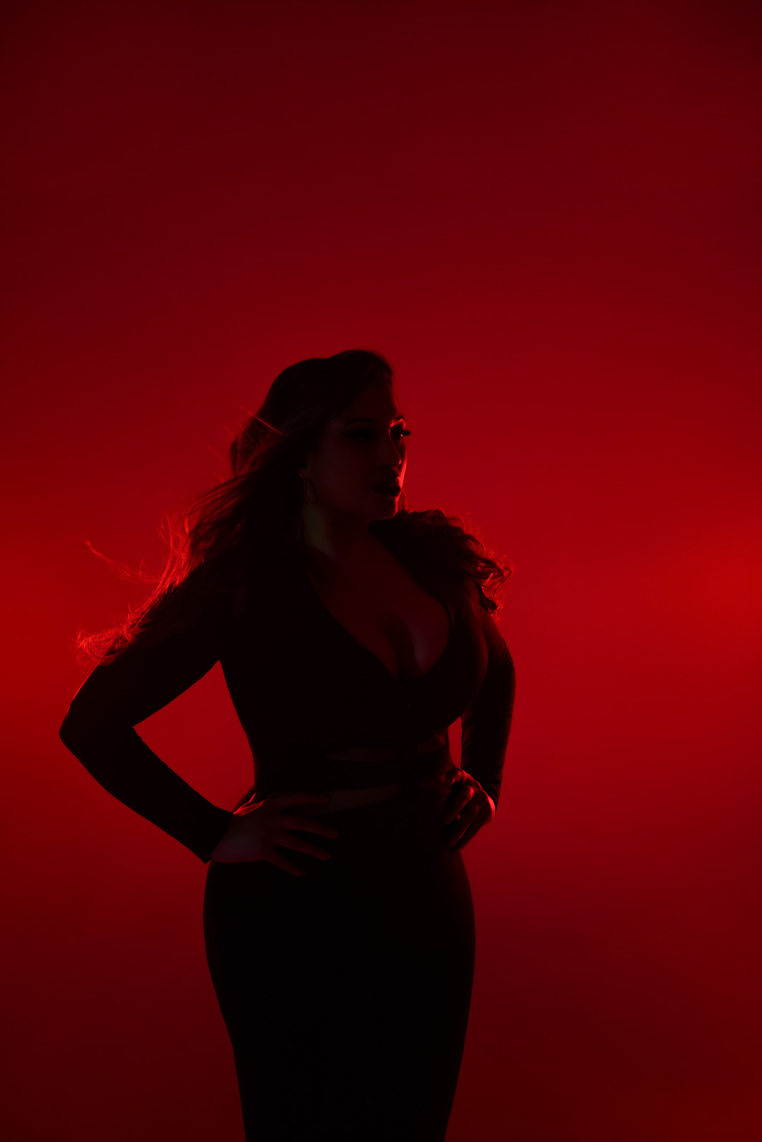 curvy-boudoir-photoshoot-London-red-room-2 Dramatic, edgy silhouette of woman with very low light and red backlighting, London